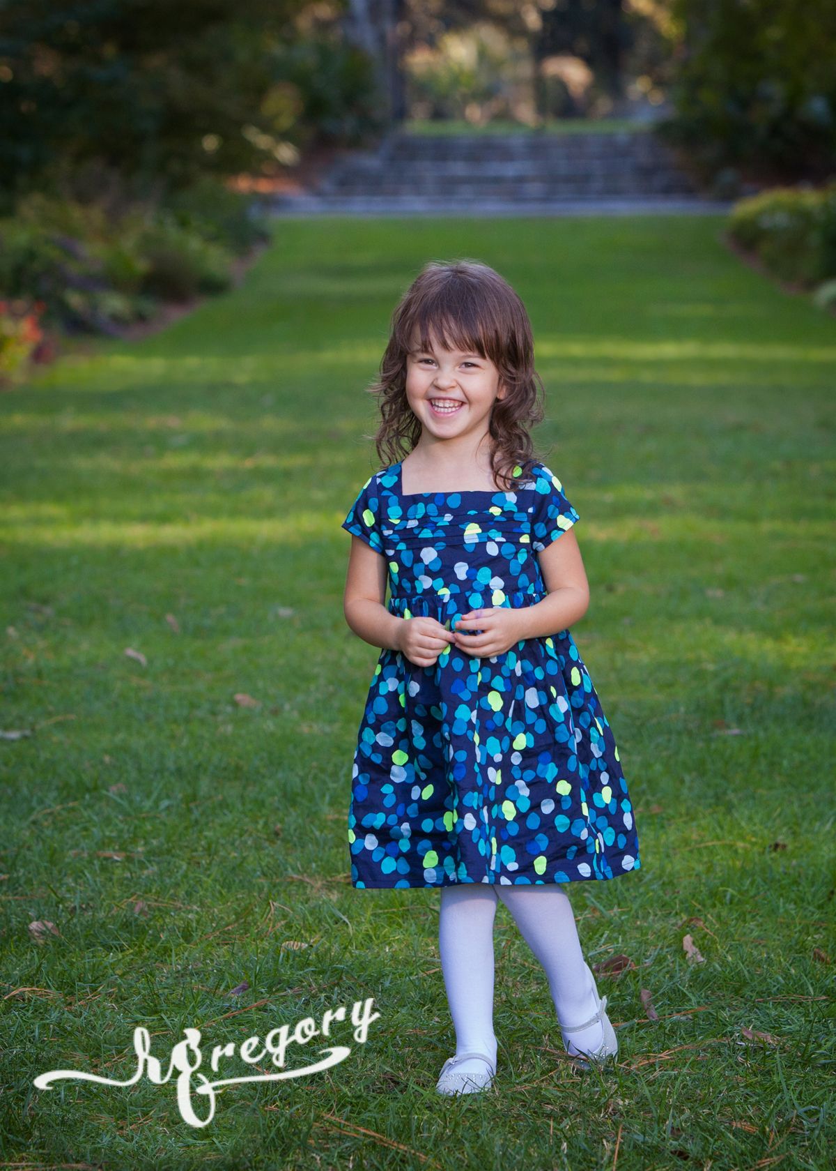 child portrait of girl in blue dress on lawn